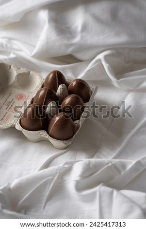 Chocolate eggs on white linen, Easter aesthetically pleasing picture, six chocolate eggs, Easter picture, present 
