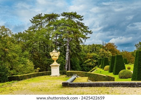 The“possession of Puss in Boots”. Perfectly trimmed grass lawns of an autumn park. Beautiful park surrounds the ancient castle of Breteuil. France Royalty-Free Stock Photo #2425422659