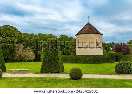 Perfectly trimmed grass lawns of an autumn park. The“possession of Puss in Boots”. Beautiful park surrounds the ancient castle of Breteuil. France Royalty-Free Stock Photo #2425422681