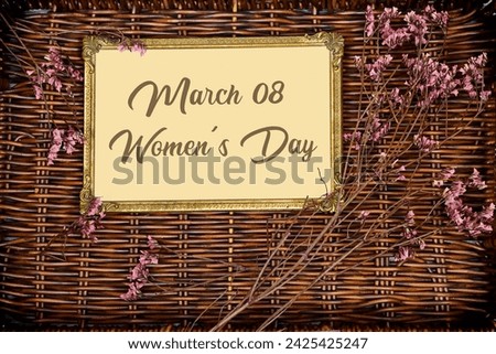 happy women's day on golden picture or photo frame mockup with pink baby's breath, gypsophila on esparto halfah background