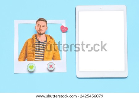 Tablet computer with photo of handsome man on blue background. Concept of online dating