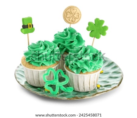 Plate with tasty green cupcakes for St. Patrick's Day on white background