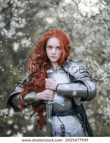 Portrait of a red-haired girl knight with a sword in a spring blooming garden