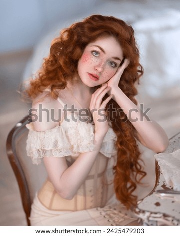 Portrait of a girl with long red hair in a lace chemise with a corset Royalty-Free Stock Photo #2425479203