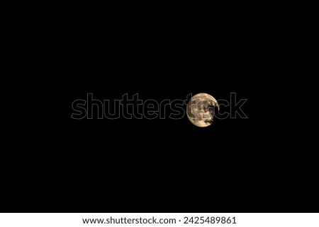Full Moon with clouds in front of. Natural night background.