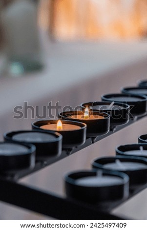  Candles for religious prayers inside a church Royalty-Free Stock Photo #2425497409