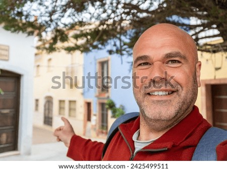 A man takes a selfie photo in the village.