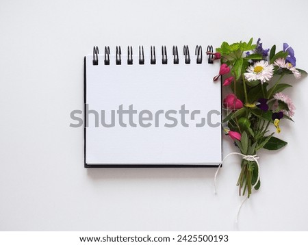 Blank notepad page for congratulatory inscriptions. Day light. Close-up, indoors. Studio shot. Finance and business concept. Congratulations for family, relatives, loved ones, friends and colleagues