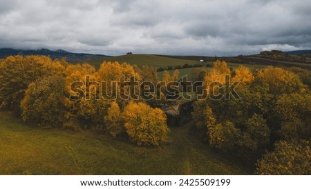 Beautiful autumn landscape photography with colourful forest, concrete bunker and mountains in background. Czechia