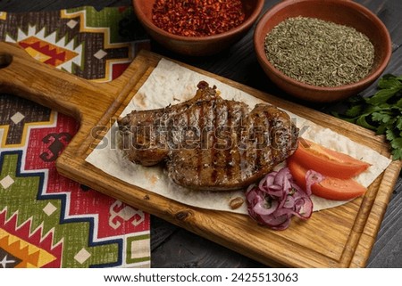 Georgian meat dishes on a dark wooden table  Royalty-Free Stock Photo #2425513063