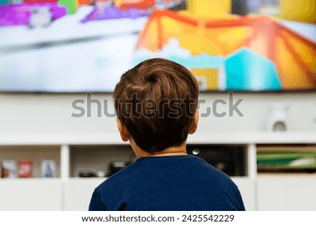 Boy watching television in a living room