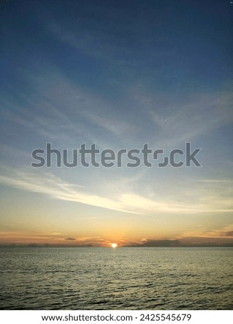 sunset light and blue sky with slightly clouds on the beach Royalty-Free Stock Photo #2425545679