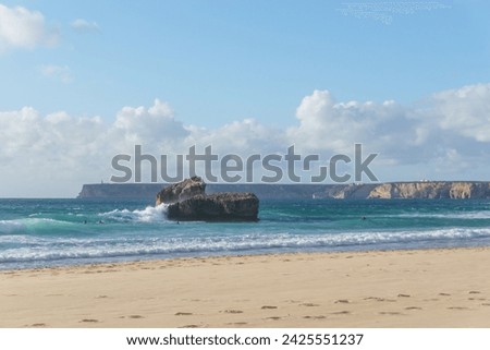 Surfer in the sea water at Praia do Tonel beach, Sagres, Algarve, Portugal