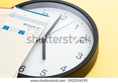 Wall clock and time card on a yellow background.
Translation: time card, attendance, clocking out, overtime, name, year, month, subtotal,
Fixed time Royalty-Free Stock Photo #2425556195