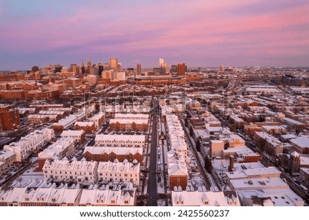 Aerial Drone View of Baltimore City Skyline with Snow Covered Houses at Sunset