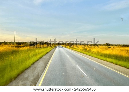 Beautiful street road in Africa with a nice landscape view. The picture is beautiful and use for background or wallpaper. Empty road with cloudy weather gives an extra beauty of nature. 
