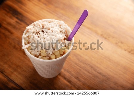 Esquites. Corn kernels cooked and served with mayo, sour cream, lemon and chili powder, very popular street food in Mexico, also known as Elote en Vaso. The recipe varies depending on the region. Royalty-Free Stock Photo #2425566807