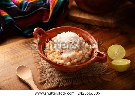Esquites. Corn kernels cooked and served with mayo, sour cream, lemon and chili powder, very popular street food in Mexico, also known as Elote en Vaso. The recipe varies depending on the region. Royalty-Free Stock Photo #2425566809