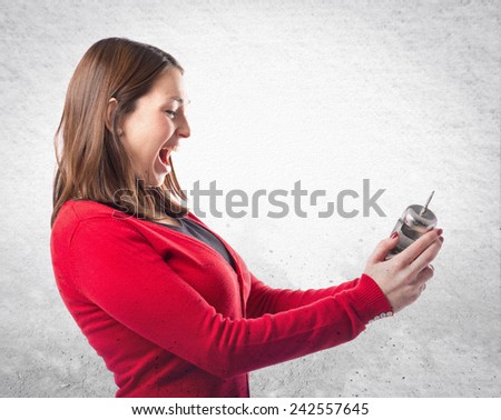 Young woman shouting and holding an antique clock over textured background 
