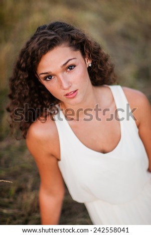 Portrait of Attractive Young Woman with Olive Skin and Curly Hair