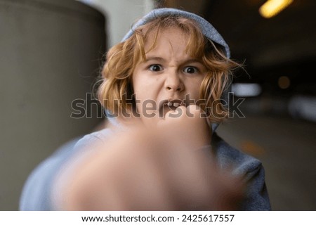 Aggressive child. Aggression kid boy fighting on street. Angry aggression kid with fist. Aggression fight kid. Bullied, physical abuse, children fighting. Aggression little boy. Kids bad behavioral. Royalty-Free Stock Photo #2425617557