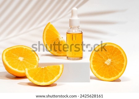 Serum oil vitamin C pipette dropper bottle on white podium copy space skin care beauty product. Anti aging antioxidant beauty serum vitamin C natural cosmetic. Royalty-Free Stock Photo #2425628161