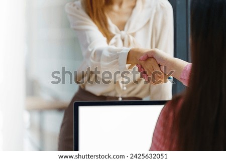 Businesswomen handshake for the teamwork of business merger and acquisition, successful negotiate, handshake, two businesswomen shake hand with a partner to celebrate the partnership.