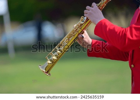 Playing soprano saxophone in outdoor Royalty-Free Stock Photo #2425635159
