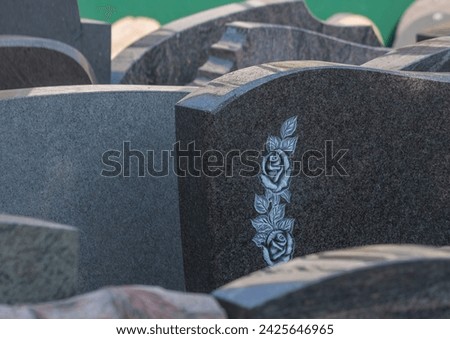 A stonemason has many gravestones for the bereaved to choose from Royalty-Free Stock Photo #2425646965