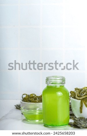 Algae based Oil, Seaweed alternative vegan oil, monounsaturated healthy fat ingredient with Algae Seaweeds Royalty-Free Stock Photo #2425658203