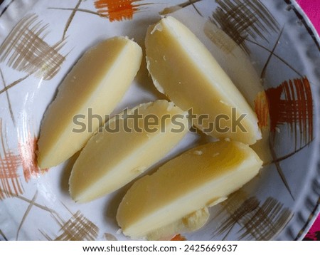 Close-up of stunning boiled potato slices served on a ceramic decorative white plate with details ultra hd hi-res  jpg stock image photo picture selective focus horizontal background top ankle view.