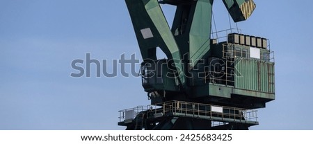 PORT CRANE - A big transshipment machine in a seaport Royalty-Free Stock Photo #2425683425