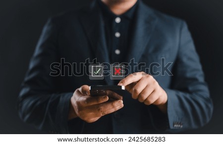 Person use smartphone choosing between right and wrong on virtual screen. Positive and negative symbols, options for decision making. Royalty-Free Stock Photo #2425685283