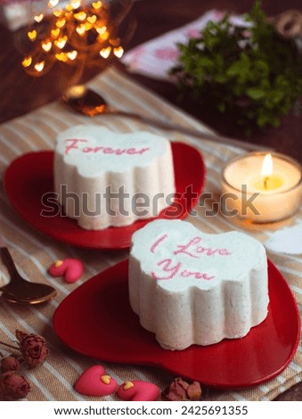 A heart shape ice-cream cake for lovers  wrote in text "I love you forever" in a red color plate with candle light with mini heart bokeh in background. Valentines and wedding ambiance