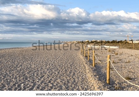 Pebble stone beach. Sea beach ocean shore. Coastline on empty pebble beach. Sea beach landscape. Coast pebbles. Shore landscape on Spain resort, Almarda. House on coastline. Waterfront vacation home