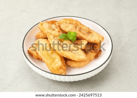 Pisang Goreng Wijen or banana fritters with sesame seed served in white plate. Indonesian food
 Royalty-Free Stock Photo #2425697513
