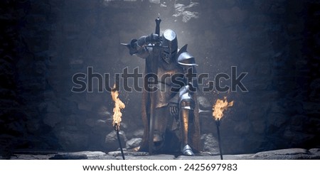 A medieval knight in full suit of armour and embroidered cape kneeling inside a castle in front of two flaming torches leaning on a broad sword in contemplation.  Royalty-Free Stock Photo #2425697983