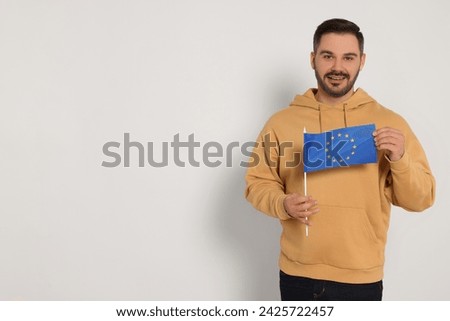 Man with flag of European Union on white background, space for text