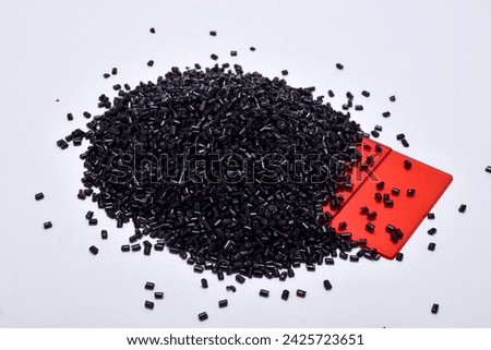 Transparent red masterbatch granules on a white background, with color chips as an example of the color produced, this polymer is a colorant for products in the plastics industry