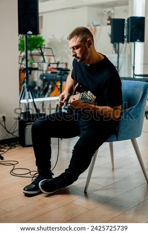 rock performer with electric guitar recording studio playing musical instrument during rehearsal