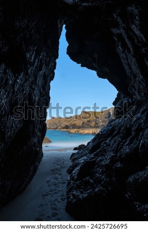 Kynance Cove beach view from a cave, long exposure photo. The Lizard Peninsula, Cornwall. South West England.