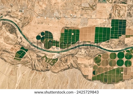 Colorado River Agriculture. Farms rise from a floodplain where the Mojave nation meets Arizona, Nevada, and California. Elements of this image furnished by NASA.