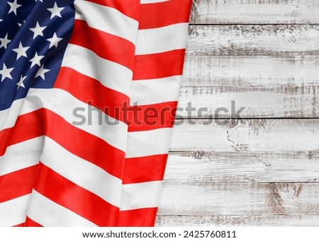 Stars and stripes american flag on rustic wooden background, top view, copy space. The pride of the American people. Symbol of independence, freedom and patriotism in the USA