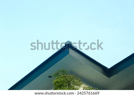 one corner of the building with a blue sky background