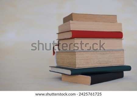 A collection of history books and encyclopedias on a yellow background
