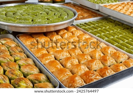 Top view of baklava varieties in trays isolated on white background.