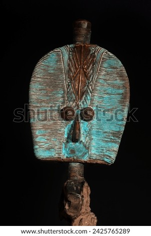 Close up of a wooden Kota reliquary figure from Gabon, isolated on a black background. Tribal African art, showcasing masterful craftsmanship and spiritual symbolism. Royalty-Free Stock Photo #2425765289