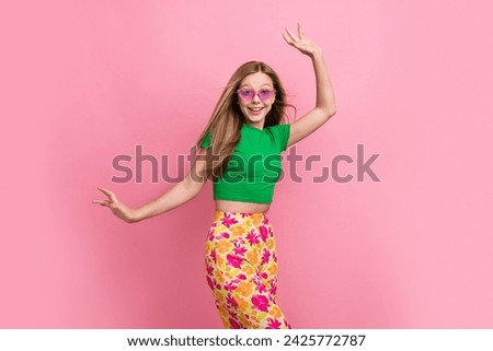 Photo portrait of lovely teen lady dancing have fun enjoy vacation dressed stylish green garment isolated on pink color background