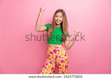 Photo portrait of lovely teen lady raise fists celebrate lottery dressed stylish green garment isolated on pink color background