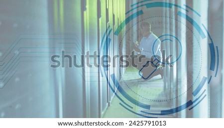 Image of data processing over african american male worker in server room. Global business and digital interface concept digitally generated image.